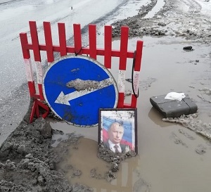 Сел в лужу: портрет Путина поставили в яму на дороге в Новосибирске